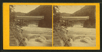 View of a bridge over a rushing stream.