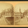 View of a street showing a church and homes.
