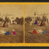View of group playing croquet, man holding woman's skirt aside for her.