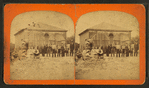 Group of boys and girls in front of unidentified brick structure.