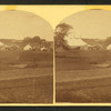 View of a fairgrounds(?), showing large tents.