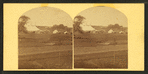 View of a fairgrounds(?), showing large tents.
