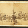 View of a large house in the snow.