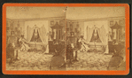 Interior view of a parlor with a woman sitting near a window.
