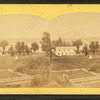 Farm land and fences in foreground.