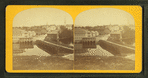 View of a bridge over a river, town in background.