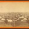 Man on a hill overlooking Boston.