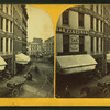 View of unidentified street with commerical buildings, trolley tracks, and buggies.
