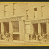 Foster, Weeks & Co. grocery, showing men with boxes out front.