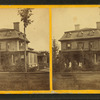 Johnson house showing the family on the porch of the wood frame home.