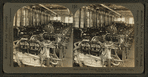 Experts testing engines in an automoblie plant.