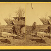 Pressing buffalo hides, Cheyanne camp.