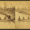 Four Indian men in a boat on Ponca creek.