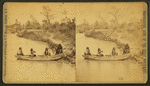 Four Indian men in a boat on Ponca creek.