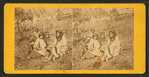 Four native Americans sitting on a hill.