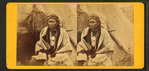 Portrait of native American man in front of teepee.