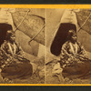 Portrait of native American woman in front of teepee.