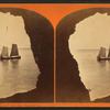 Palisade cave, showing two masted boat framed in mouth of cave.