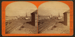 Railroad tracks and steamboats moored at piers along the lake.