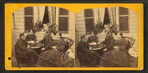 People on a porch -- two men playing chess accompanied by two women.