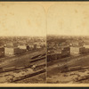 General view with buildings and Railroad yard.