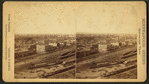 General view with buildings and Railroad yard.