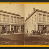 View of building with people in front of it.