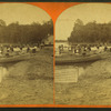 View of people in boats and swimming in the lake.