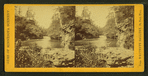 View of a river, with both banks, rock formations, and trees.