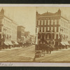 View of a clothing house and other stores in the commercial area in St. Louis.