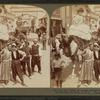 Dancing girls riding on camels through street in 'Mysterious Asia'.