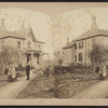 iew of a couple and a child in front of their home.