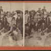 roup of men and women at the beach.