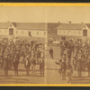 Taken at Fort Wingate, Dec. 11, 1871 [a group of native Americans and Burros in front of a building.]