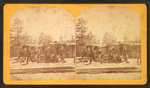 Group of men in front of a log cabin.