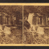 Man sitting near the waterfall.