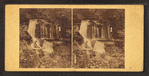 Man sitting near the waterfall.