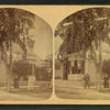 View of a man and woman standing in a street corner, Nashua.