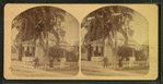 View of a man and woman standing in a street corner, Nashua.