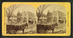 View of homes, and horse-drawn carts.