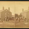 Group of people in front of a House.