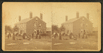 Group of people in front of a House.