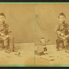 Little boy with a block of wood, carving tools and a doll.