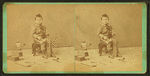 Little boy with a block of wood, carving tools and a doll.