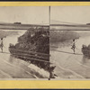 Man crossing over the river on a cable wire, Niagara Falls.]