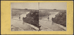 Man crossing over the river on a cable wire, Niagara Falls.