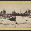 Snow and ice on river, with parts of machinery against shore.