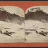 View of rapids, residential building in the background.