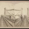 Niagara Suspension Bridge. [Man in a top hat standing on railroad tracks.]