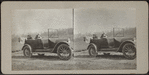 Women attending to a child in touring car.